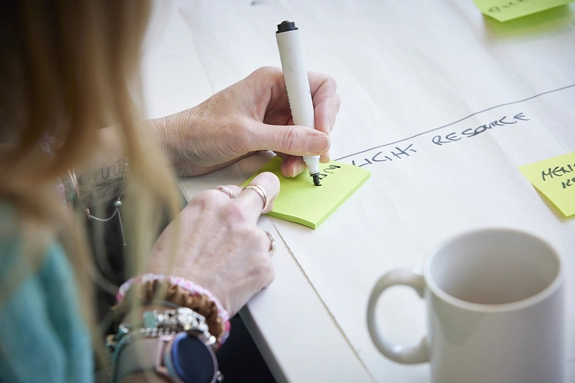 Woman planning writing notes on a sticky pad