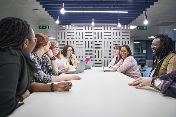 Staff around table in a meeting